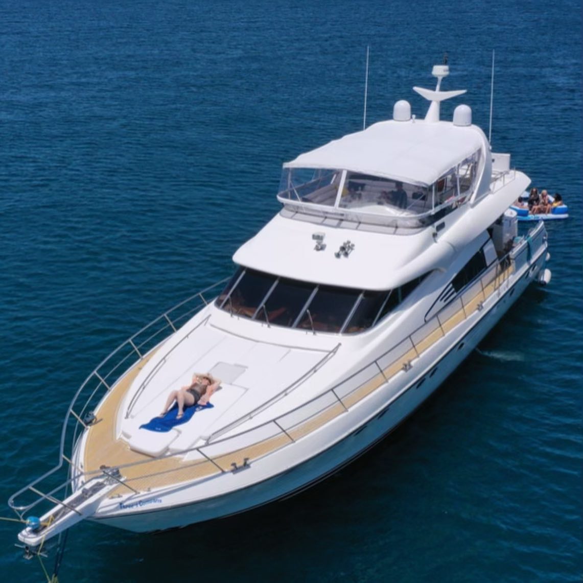 Three's Company luxury yacht charter cruising in Marina del Rey with guests relaxing on the bow